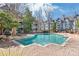 Community pool with brick surround and lounge chairs at 525 N Graham St # 2F, Charlotte, NC 28202