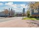 Street view featuring brick-paved road, trees and buildings under a bright sky at 525 N Graham St # 2F, Charlotte, NC 28202