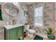 Stylish half-bath with patterned wallpaper, green vanity, gold fixtures, and lots of personality at 5431 Meadowcroft Way, Fort Mill, SC 29708