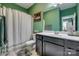 Well-lit bathroom with a shower-tub combo, and a dark vanity with a white countertop and sink at 5431 Meadowcroft Way, Fort Mill, SC 29708