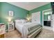 Calming bedroom features light green walls, white accents and bedding, with a clean and relaxing ambiance at 5431 Meadowcroft Way, Fort Mill, SC 29708