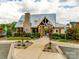 Charming community clubhouse with stone accents and ample green space, creating a welcoming atmosphere at 5431 Meadowcroft Way, Fort Mill, SC 29708