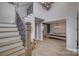 Spacious foyer featuring staircase with iron spindles and open access to the dining and living areas at 5431 Meadowcroft Way, Fort Mill, SC 29708