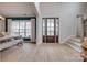 Bright foyer with soaring ceilings, beautiful wood-look floors and an elegant wood and glass front door at 5431 Meadowcroft Way, Fort Mill, SC 29708