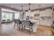 Bright, modern kitchen with white cabinets, marble backsplash, and large island with pendant lighting and seating at 5431 Meadowcroft Way, Fort Mill, SC 29708