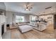 Open-concept living room featuring a fireplace, neutral color palette, and lots of seating at 5431 Meadowcroft Way, Fort Mill, SC 29708