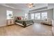 Spacious primary bedroom featuring trey ceiling, large windows and sitting area at 5431 Meadowcroft Way, Fort Mill, SC 29708