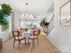 Open-concept dining room with hardwood floors and views of the living room, filled with natural light at 5711 Castlerea Dr, Charlotte, NC 28217
