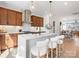 Modern kitchen with stainless appliances, center island with chairs, and a view into the dining area at 5711 Castlerea Dr, Charlotte, NC 28217