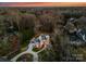 An aerial view of a brick two-story house surrounded by tall trees and lush landscaping at 5824 Preston Ln, Charlotte, NC 28270