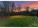 Beautiful backyard area featuring green grass, a soccer net and tall trees at 5824 Preston Ln, Charlotte, NC 28270