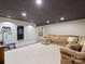 Finished basement with comfortable seating, exercise equipment, and neutral color scheme at 5824 Preston Ln, Charlotte, NC 28270