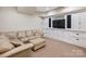 Cozy basement featuring a comfortable seating area and built in media storage, perfect for entertainment at 5824 Preston Ln, Charlotte, NC 28270
