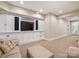 Finished basement offering a spacious seating area with custom built-in media storage at 5824 Preston Ln, Charlotte, NC 28270