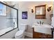 Modern bathroom features a glass-enclosed shower and a pedestal sink at 5824 Preston Ln, Charlotte, NC 28270