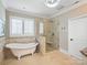 A spa-like bathroom with a freestanding tub and a frameless glass shower with tiled accents at 5824 Preston Ln, Charlotte, NC 28270