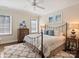 Bright bedroom with hardwood floors, a ceiling fan, and natural light at 5824 Preston Ln, Charlotte, NC 28270