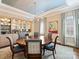 Elegant dining room features a round table, chandelier, and built-in bar area, perfect for entertaining guests at 5824 Preston Ln, Charlotte, NC 28270