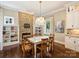 Dining area features a stone fireplace, decorative lighting, and hardwood floors at 5824 Preston Ln, Charlotte, NC 28270