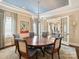 Sophisticated dining room featuring a round table and elegant chandelier, ideal for formal gatherings at 5824 Preston Ln, Charlotte, NC 28270