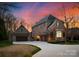 Stunning brick home featuring an attached three car garage and a circular driveway at 5824 Preston Ln, Charlotte, NC 28270