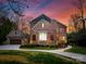 Beautiful two-story brick home with a three-car garage and circular driveway at 5824 Preston Ln, Charlotte, NC 28270