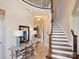 Grand foyer with a curved staircase, elegant lighting, and views into the inviting living spaces at 5824 Preston Ln, Charlotte, NC 28270