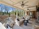 Inviting covered porch with ceiling fans, comfortable seating, and view of the backyard pool at 5824 Preston Ln, Charlotte, NC 28270