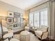Cozy sitting room featuring natural light, stylish furniture, and curated artwork creating a relaxing atmosphere at 5824 Preston Ln, Charlotte, NC 28270