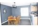Stylish dining area features dark grey walls, hardwood floors, a modern light fixture, and a view into the kitchen at 610 Trillium Sw Ct # 14, Conover, NC 28613