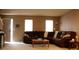 Comfortable living room featuring a large sectional sofa, neutral walls, and ample natural light from two windows at 610 Trillium Sw Ct # 14, Conover, NC 28613