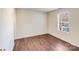 Bedroom featuring laminate floors, neutral walls, and a window for plenty of natural light at 7712 Grapetree Ct, Charlotte, NC 28215