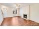 Inviting living room with a fireplace and large windows for ample natural light at 7712 Grapetree Ct, Charlotte, NC 28215