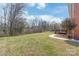 Expansive backyard featuring a wooden deck and mature landscaping offering privacy at 7925 Tottenham Dr, Harrisburg, NC 28075