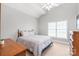 Bright bedroom with light walls, a ceiling fan, and a window at 7925 Tottenham Dr, Harrisburg, NC 28075