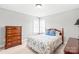 Cozy bedroom with hardwood furniture, soft natural light, and a comfortable queen bed at 7925 Tottenham Dr, Harrisburg, NC 28075