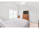 Light and bright bedroom with large tv and ceiling fan at 7925 Tottenham Dr, Harrisburg, NC 28075