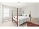 Bright bedroom with a four poster bed and a sunlit window at 7925 Tottenham Dr, Harrisburg, NC 28075