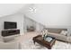 Bright bonus room featuring a sofa and a seating area at 7925 Tottenham Dr, Harrisburg, NC 28075