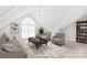 Sunlit bonus room with vaulted ceilings and cozy seating area at 7925 Tottenham Dr, Harrisburg, NC 28075