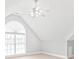 Bonus room with a ceiling fan and an arched window at 7925 Tottenham Dr, Harrisburg, NC 28075