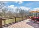 Back deck with an outdoor seating area and a wooded view at 7925 Tottenham Dr, Harrisburg, NC 28075