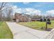 Traditional red brick home with manicured lawn and long driveway at 7925 Tottenham Dr, Harrisburg, NC 28075