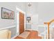 Bright foyer with hardwood floors, chandelier, and staircase with wooden banister at 7925 Tottenham Dr, Harrisburg, NC 28075