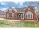 Charming brick home with a well-manicured lawn, blue front door, and bright windows at 7925 Tottenham Dr, Harrisburg, NC 28075