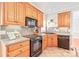 Traditional kitchen features classic oak cabinets and modern appliances at 7925 Tottenham Dr, Harrisburg, NC 28075