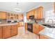Well-equipped kitchen features oak cabinets and tile flooring at 7925 Tottenham Dr, Harrisburg, NC 28075