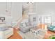 Bright, open-concept living room with staircase and view into the dining room at 7925 Tottenham Dr, Harrisburg, NC 28075