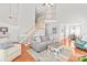 Bright, open-concept living room with staircase and view into the dining room at 7925 Tottenham Dr, Harrisburg, NC 28075