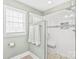 Contemporary bathroom with frameless glass shower and tiled walls at 7925 Tottenham Dr, Harrisburg, NC 28075